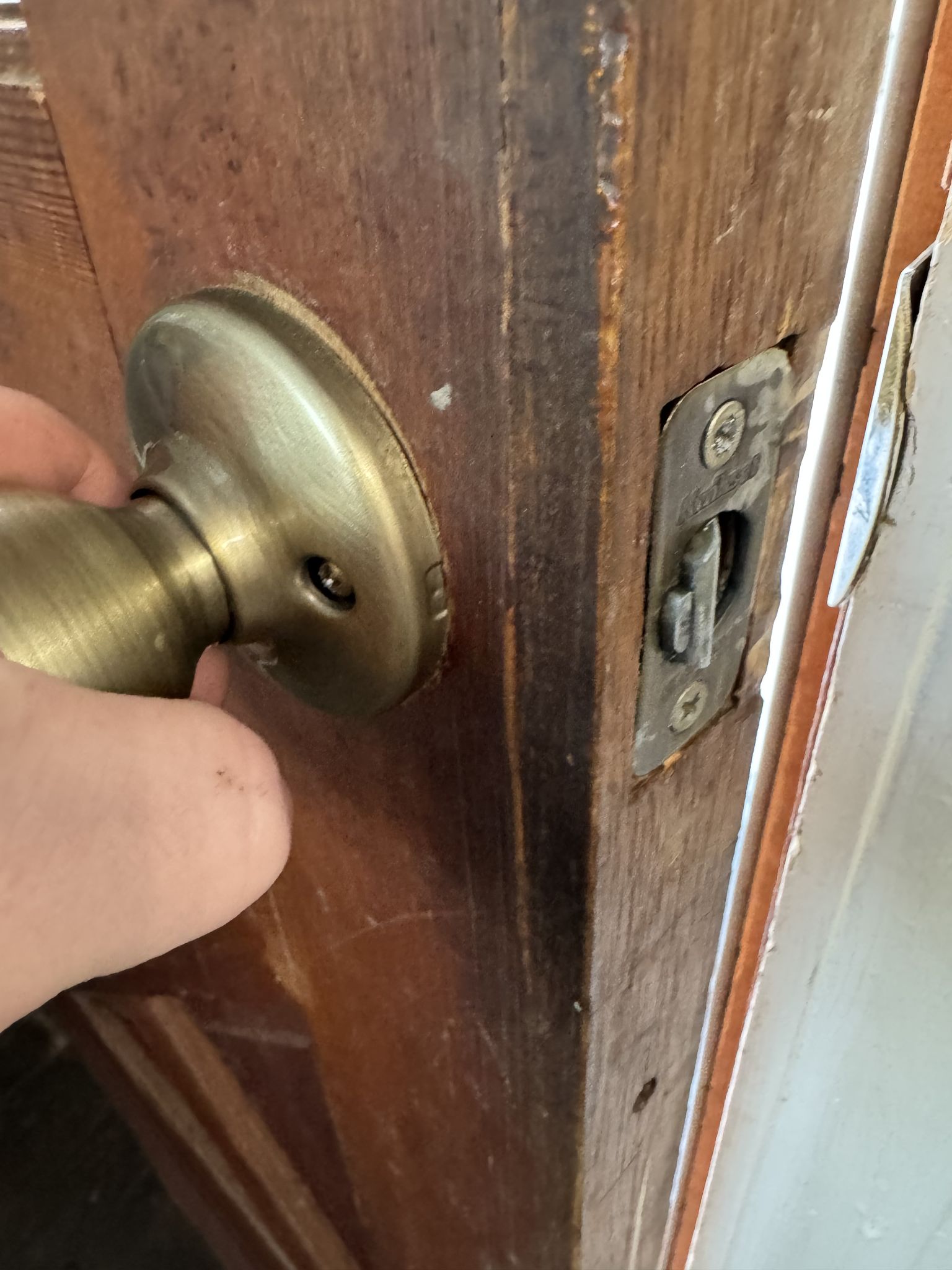 Took it apart, jammed it with a screwdriver and beat it with a hammer. Still barely closes, but improved. Alright, let’s see who’s behind this garbage.