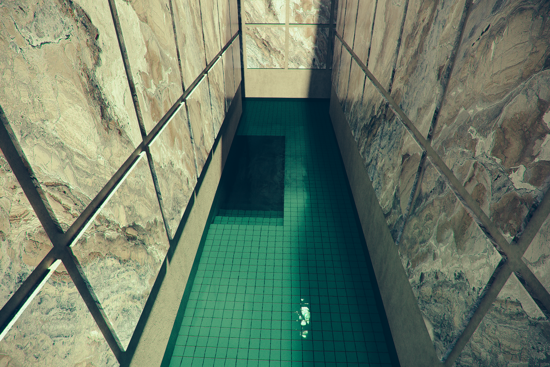 A hallway lined with large marble tiles. The ground is flooded with shallow green-blue water.  A flooded staircase fades into darkness.