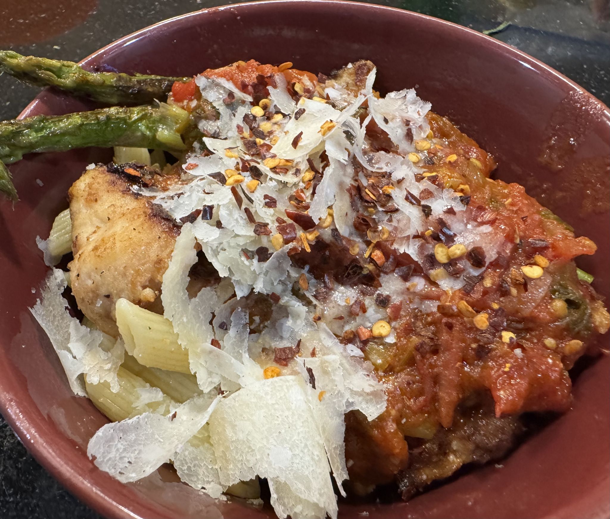 Homemade sauce with tomatoes, basil and oregano from the garden as well as onions, shallots and garlic; cast iron asparagus with lemon and chicken; pecorino Romano and crushed red pepper