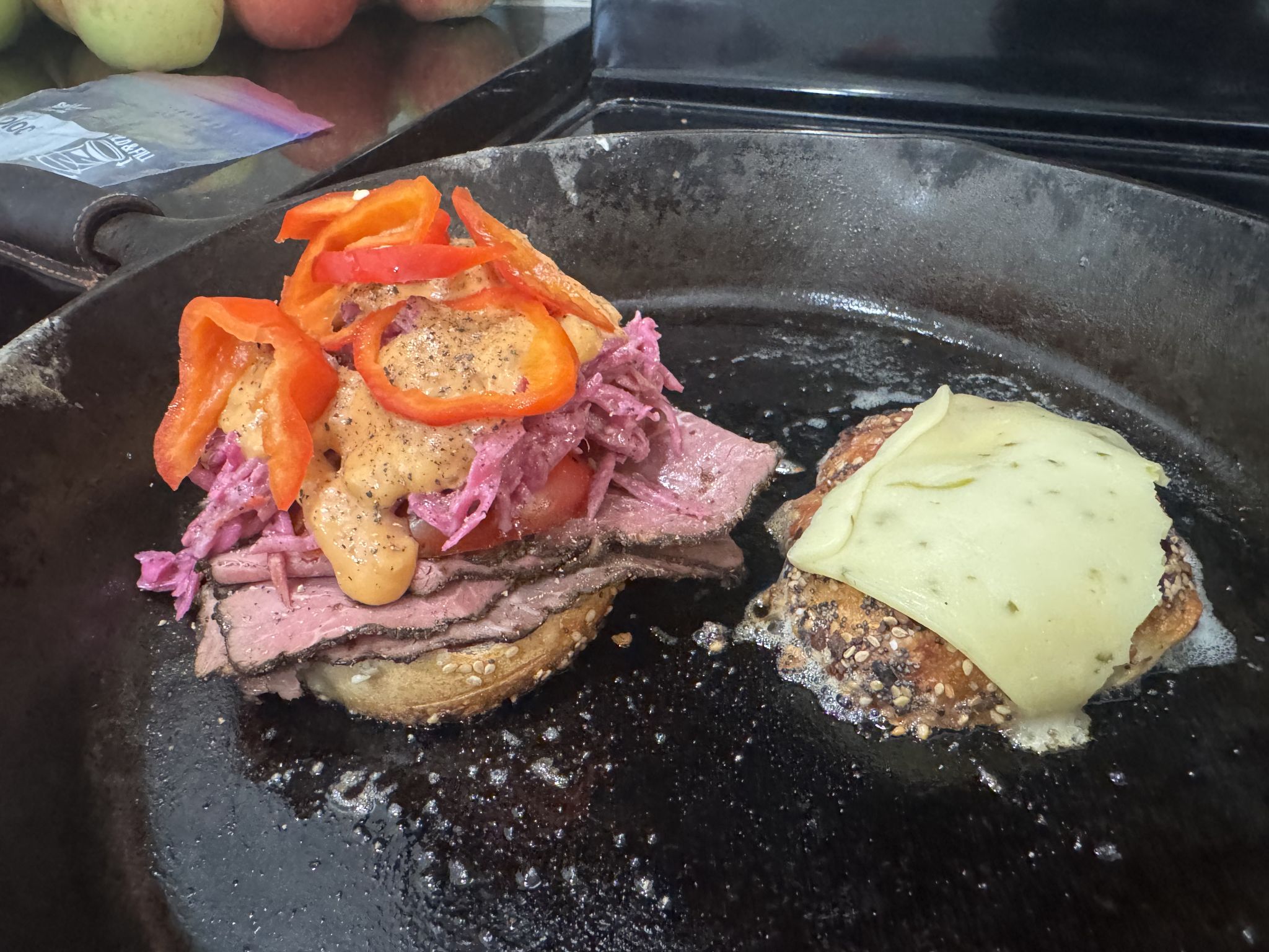 Sliced a half everything bagel in half, toasted in cast iron in butter with jack cheese, pastrami, Cole slaw, and Russian dressing 