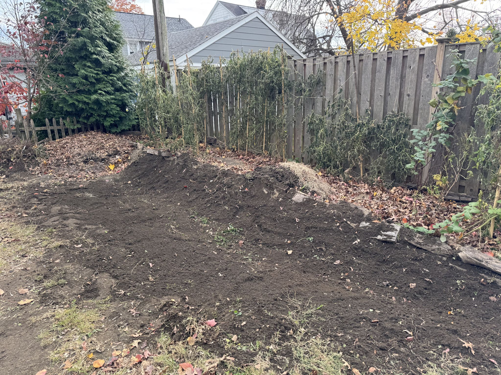Updated slope, dug the dirt to create a gradual slope down and used some of the excess to pack the wood on the garden bed hill 